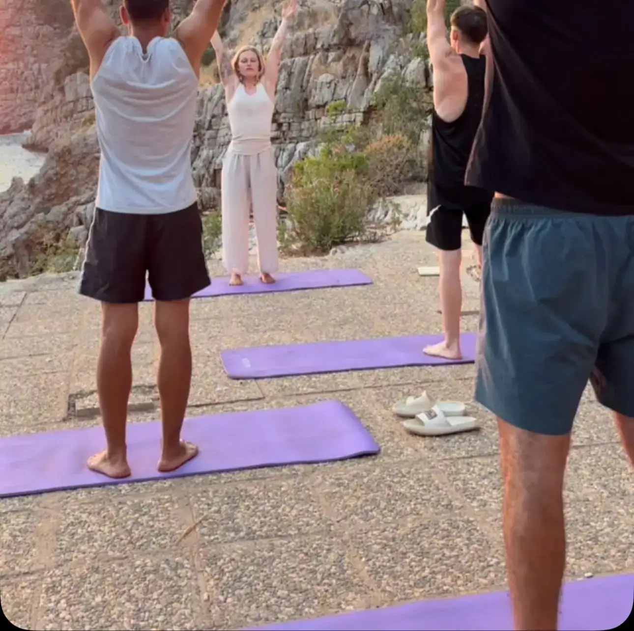 Group movement class outdoors on mats